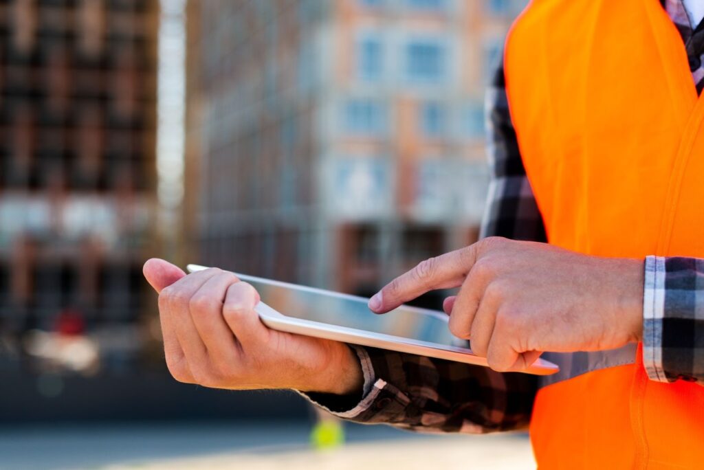 Contractor managing project tasks with Constructor Foreman on an iPad
